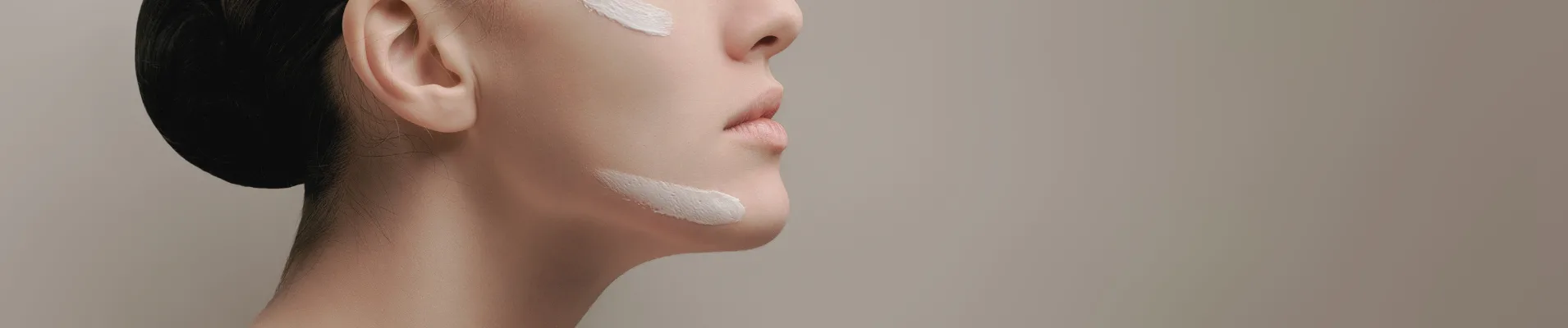 女性細緻肌膚線條與天然乳霜塗抹質感的極簡美學特寫。AMIRA 官網臉部產品系列、純淨自然護膚與低敏肌膚調理精華。